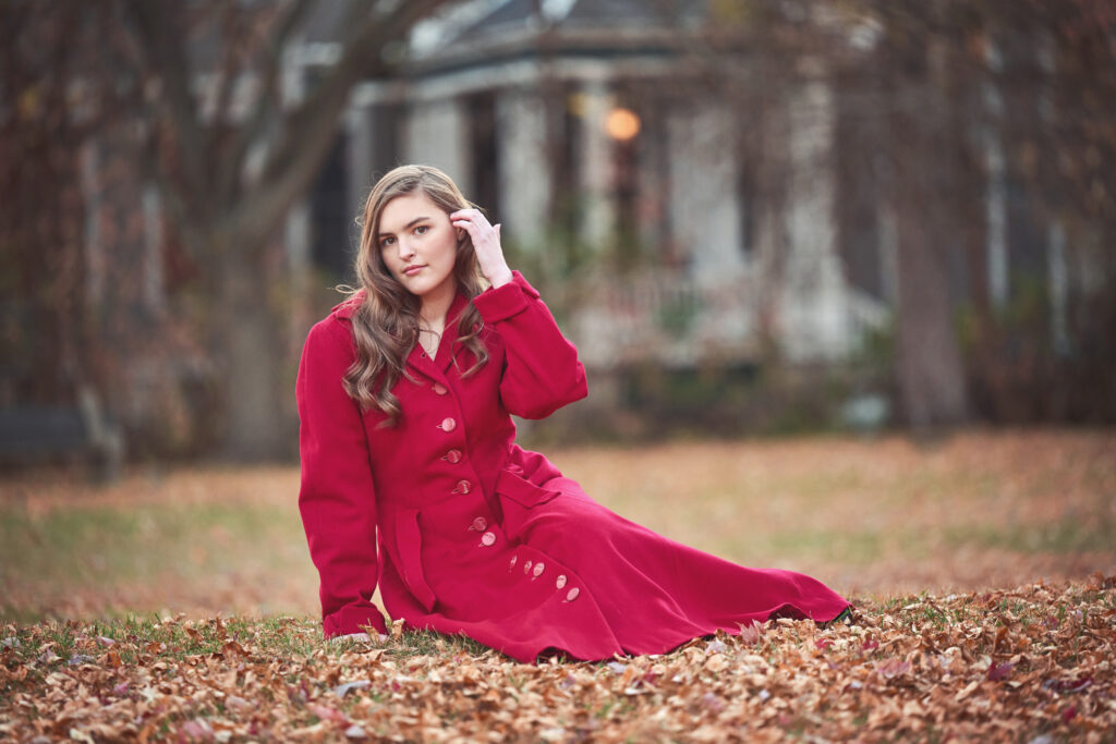 Senior Portrait accessories and what to wear. Person wearing a long jacket and necklace