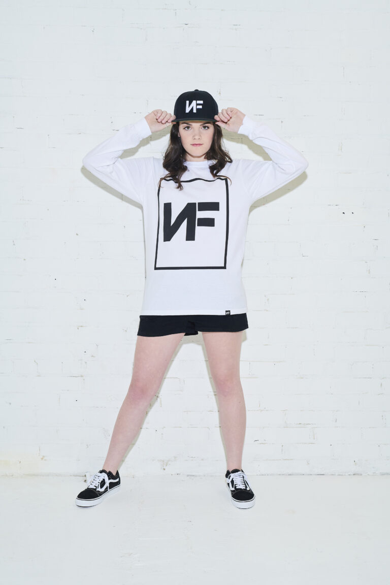 a woman in a white shirt and black shorts