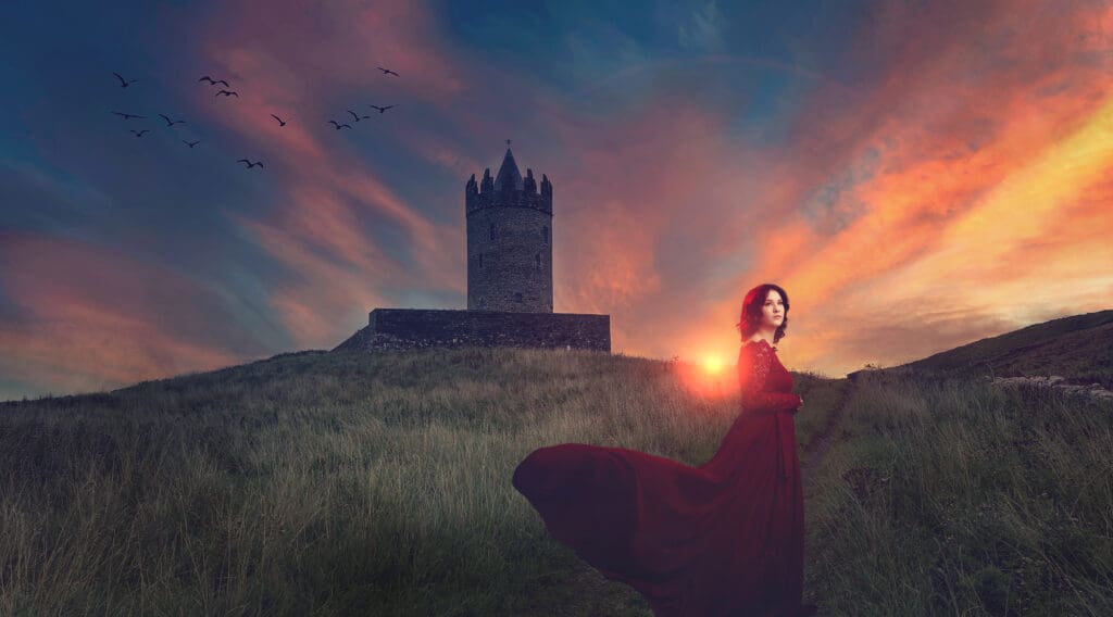 senior photos with castle in Ireland sunset red dress