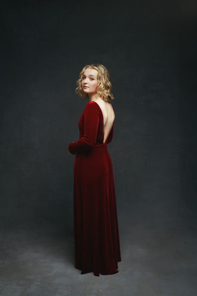 Dramatic senior picture of girl in red dress with low back for senior pic with megan Engeseth photographer