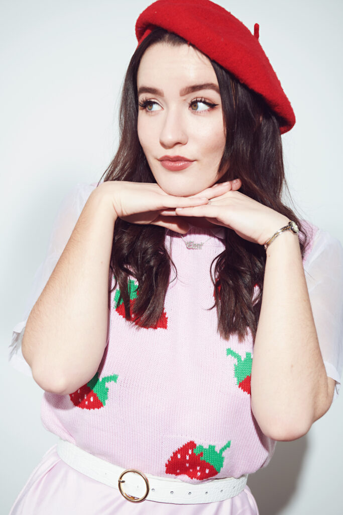 Artistic Portrait of a Woman in Red Beret With Strawberry Sweater