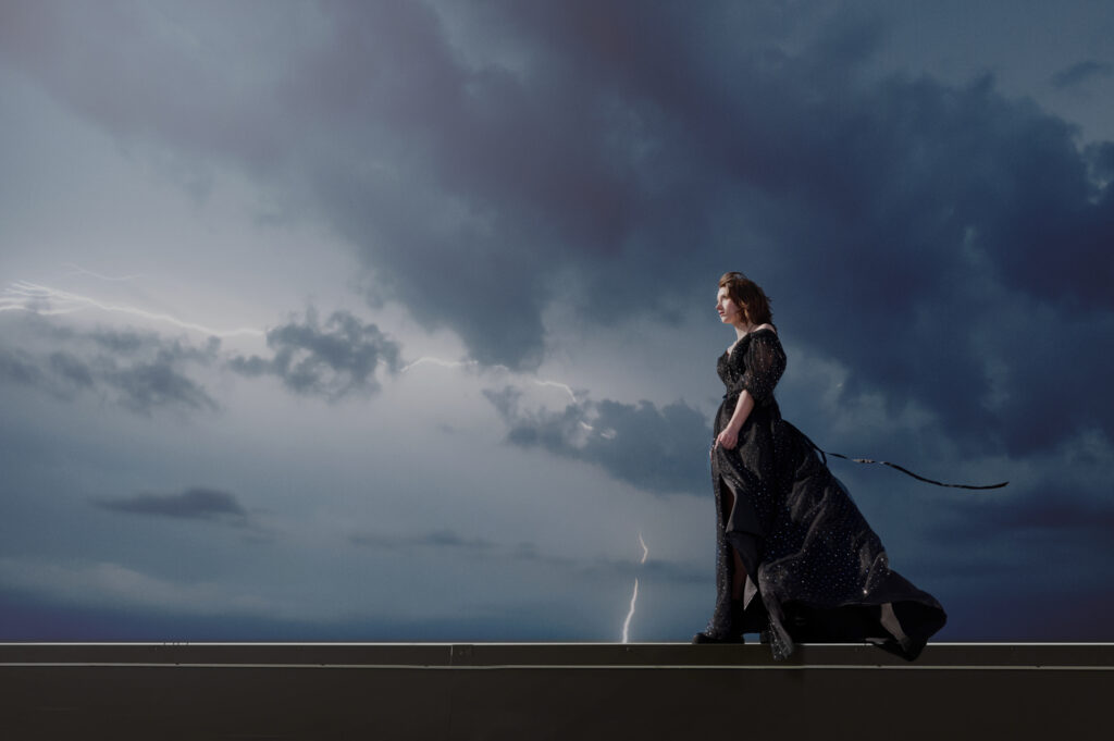 Best senior portrait photographer in Minneapolis showcases a dramatic senior picture with thunderstorms. 