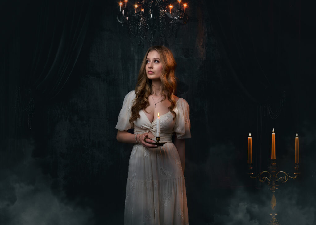 a woman in a white dress holding a candle