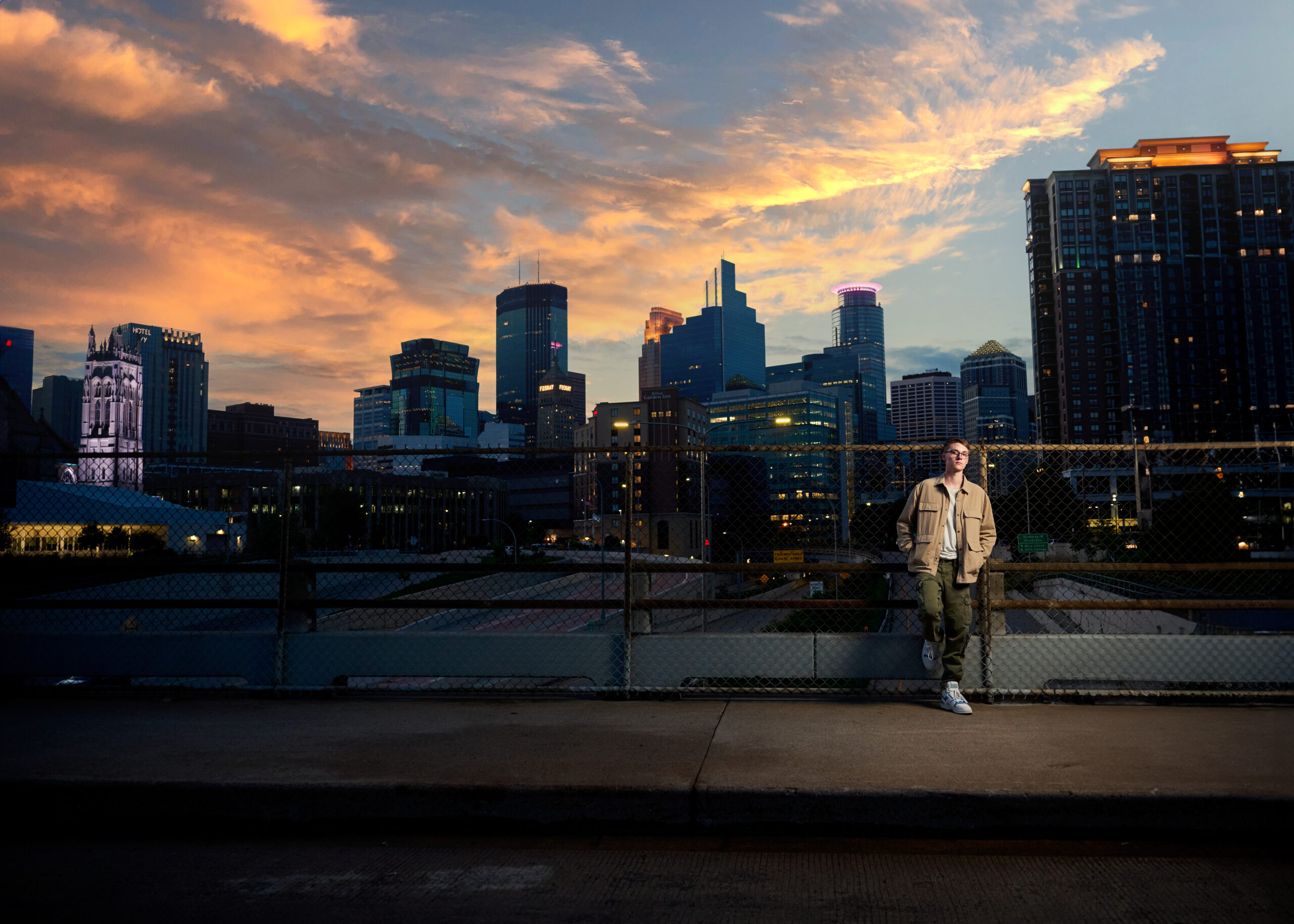 Urban Evening Senior Picture Photographer Highlighting Downtown Skyline