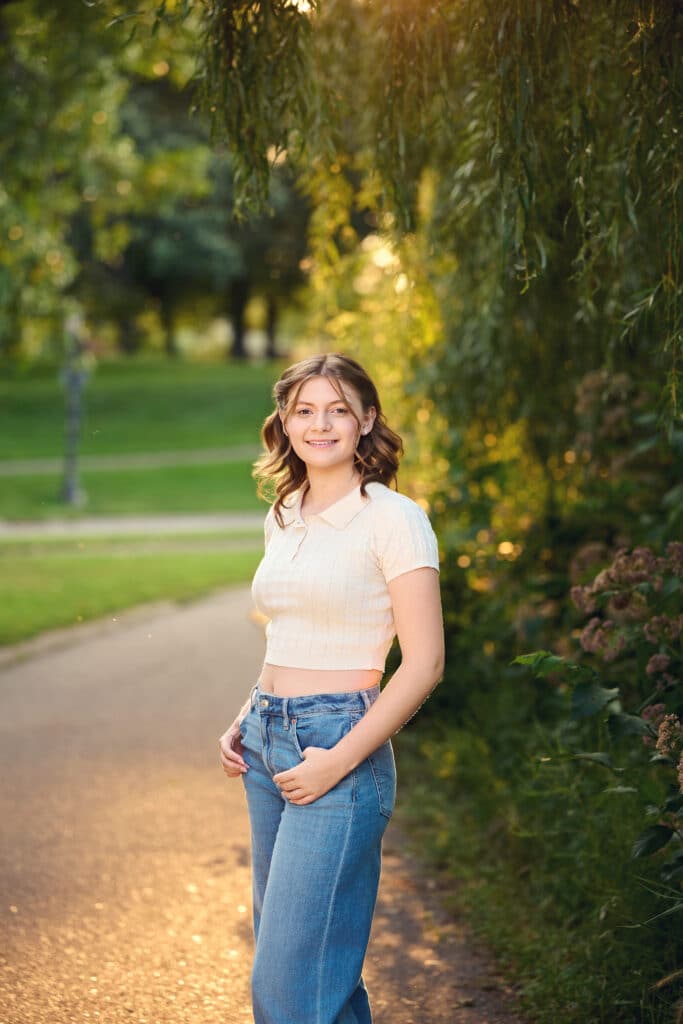 Edina senior pictures featuring a relaxed outdoor portrait near water and walking paths