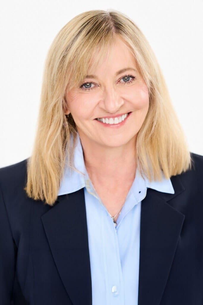 Professional headshot of woman in navy blazer and blue shirt on white background St. Paul studio Megan Engeseth Photography