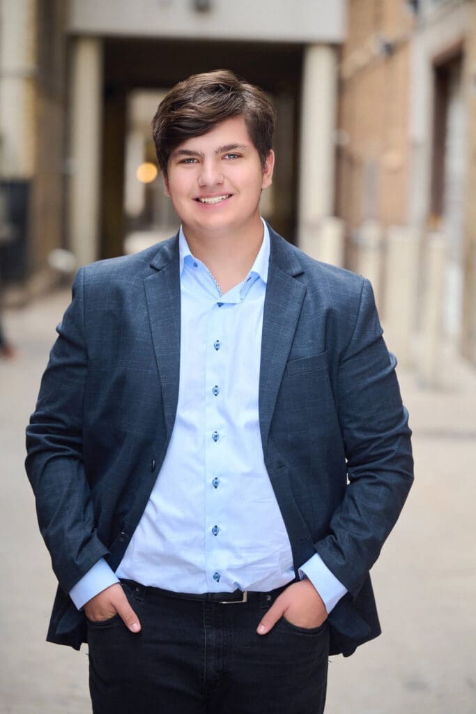 Senior picture of guy with his hands in his pockets in an alley in Woodbury MN.